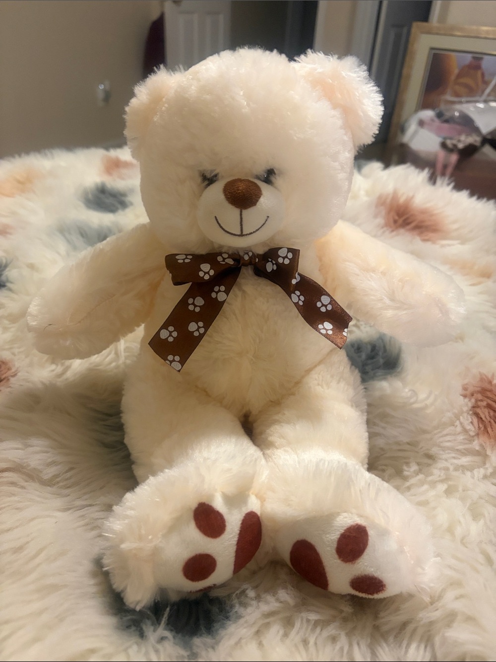 Cream Plush Teddy Bear with Brown Paw Print Ribbon